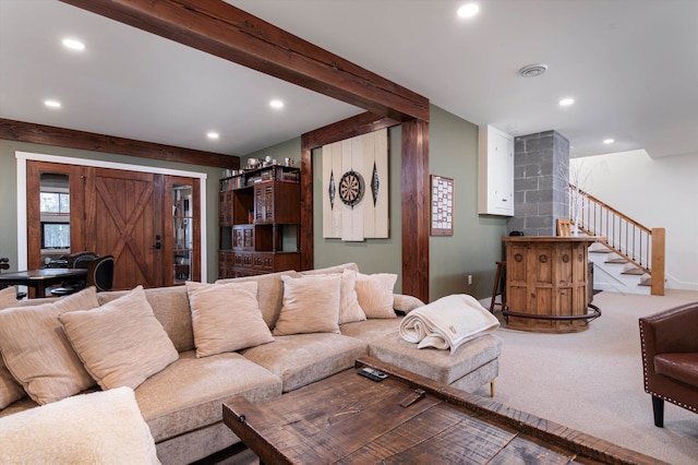 carpeted living room with beamed ceiling