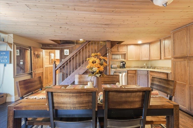 dining area featuring light hardwood / wood-style floors, wood ceiling, and sink