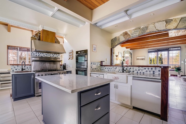 kitchen with backsplash, white cabinetry, white dishwasher, sink, and a center island