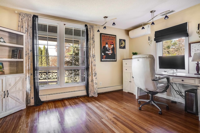 unfurnished office featuring an AC wall unit, wood-type flooring, and a textured ceiling