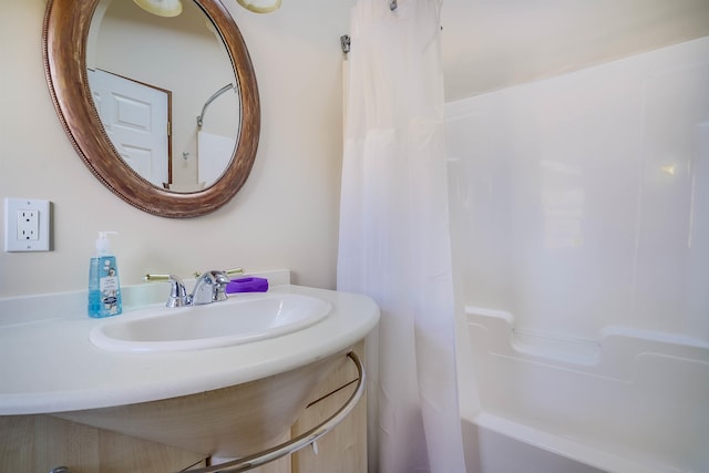 bathroom featuring vanity and shower / tub combo