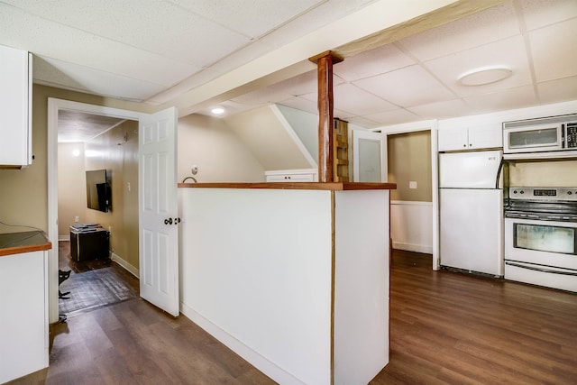 kitchen featuring white cabinets, white appliances, and dark hardwood / wood-style flooring