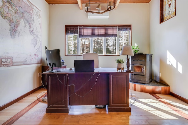 office area featuring light hardwood / wood-style flooring and beamed ceiling