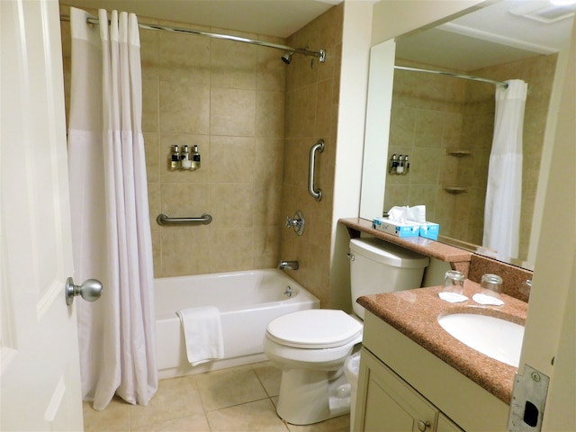 full bathroom featuring toilet, vanity, tile patterned floors, and shower / tub combo