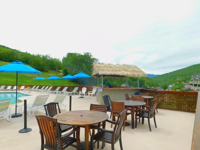 view of patio / terrace featuring a mountain view and a community pool