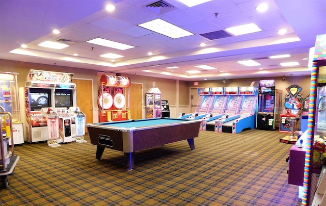 recreation room with a tray ceiling, pool table, and dark colored carpet