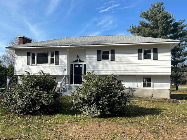 bi-level home with a front lawn