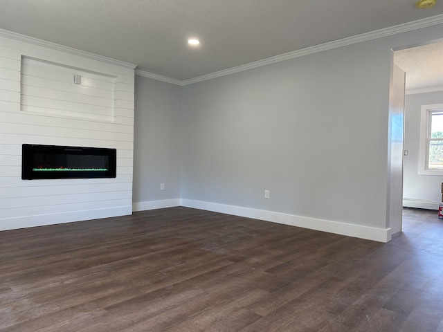 unfurnished living room featuring dark hardwood / wood-style flooring, a textured ceiling, a large fireplace, and crown molding