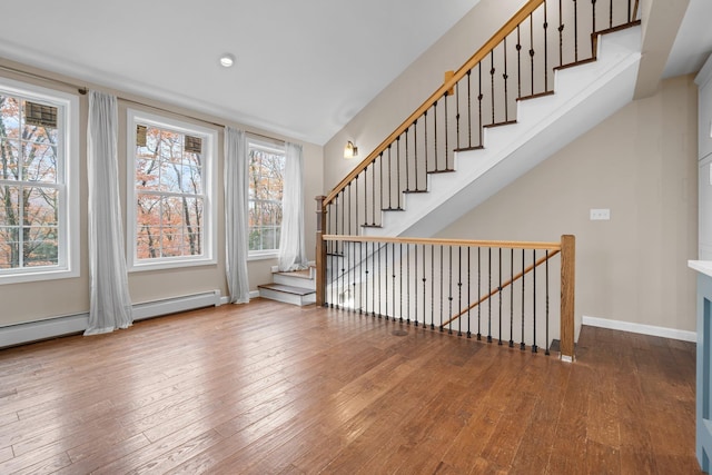155 E Shore Dr, Weare, NH 03281 - stairway with hardwood / wood-style flooring, baseboards, and a baseboard heating unit