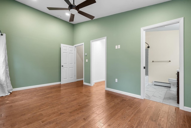 155 E Shore Dr, Weare, NH 03281 - unfurnished bedroom featuring a baseboard radiator, baseboards, wood finished floors, recessed lighting, and connected bathroom