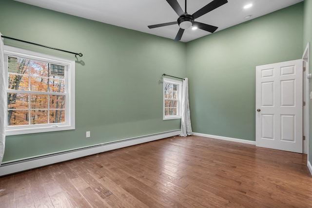 155 E Shore Dr, Weare, NH 03281 - unfurnished room featuring a baseboard radiator, ceiling fan, wood finished floors, baseboards, and high vaulted ceiling