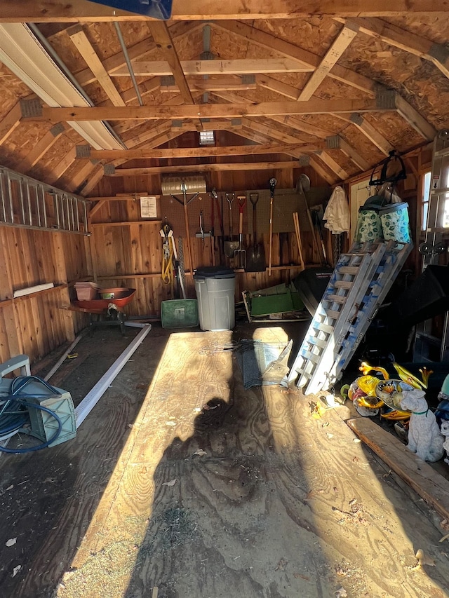 interior space featuring wood walls and vaulted ceiling