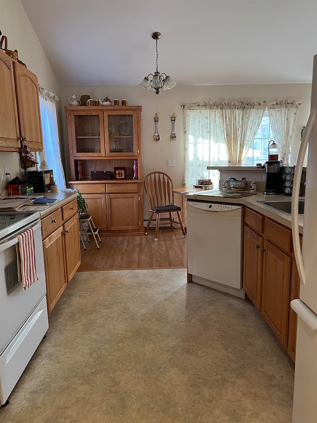 kitchen with hanging light fixtures, a notable chandelier, vaulted ceiling, white appliances, and light wood-type flooring