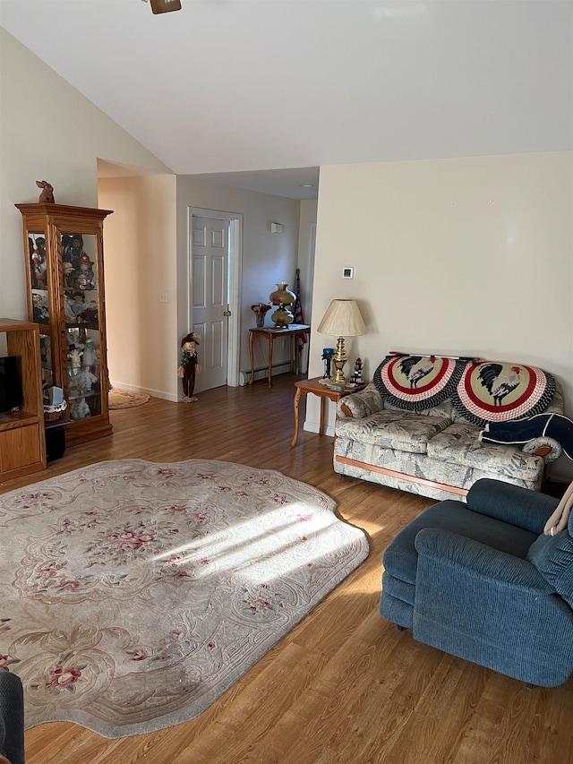 living room featuring a baseboard radiator, vaulted ceiling, and hardwood / wood-style flooring