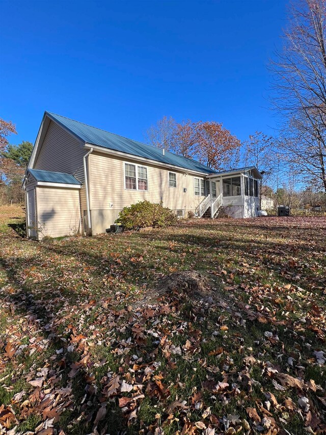 rear view of property with a sunroom