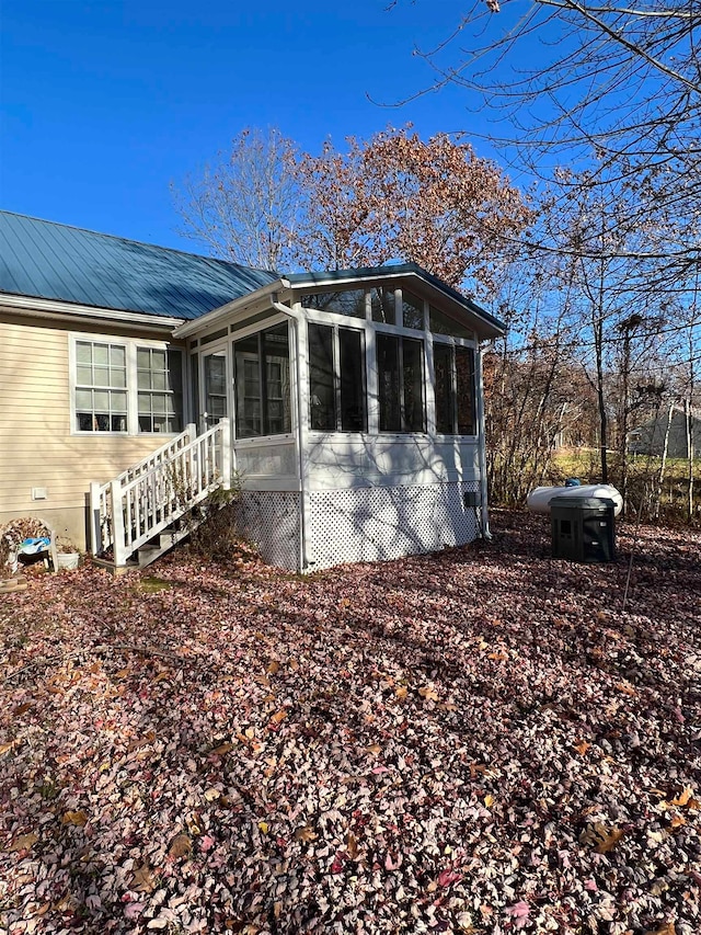 view of property exterior featuring a sunroom