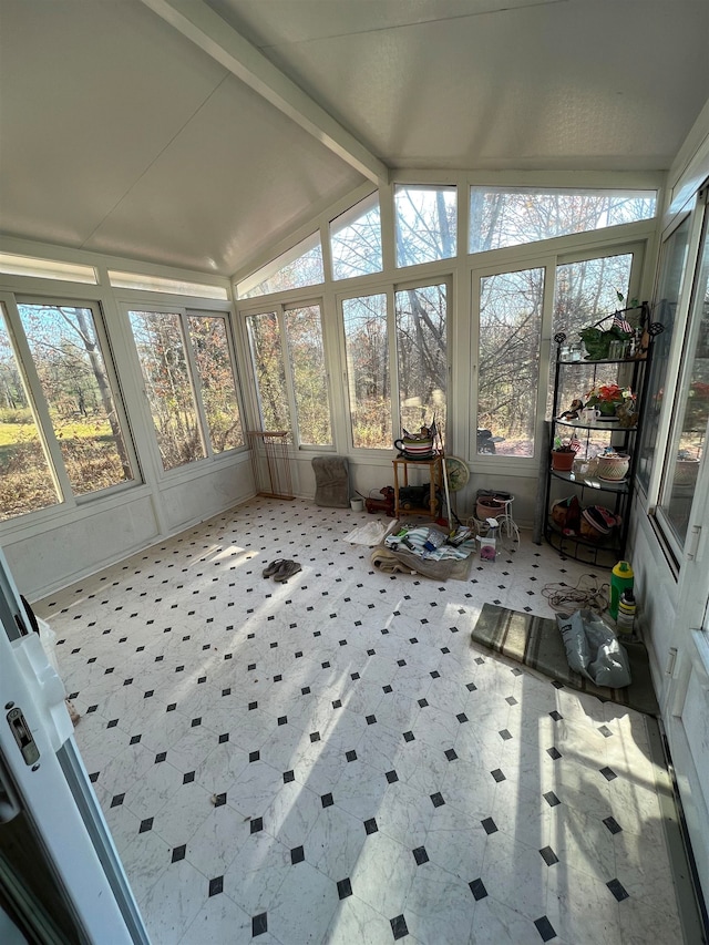 sunroom / solarium with vaulted ceiling with beams