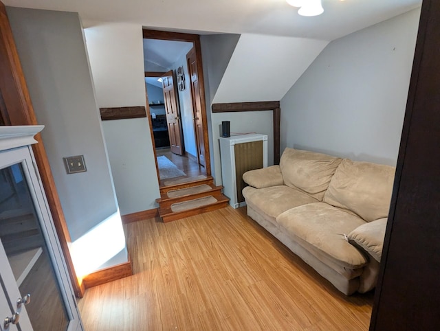 living room with lofted ceiling and light hardwood / wood-style flooring