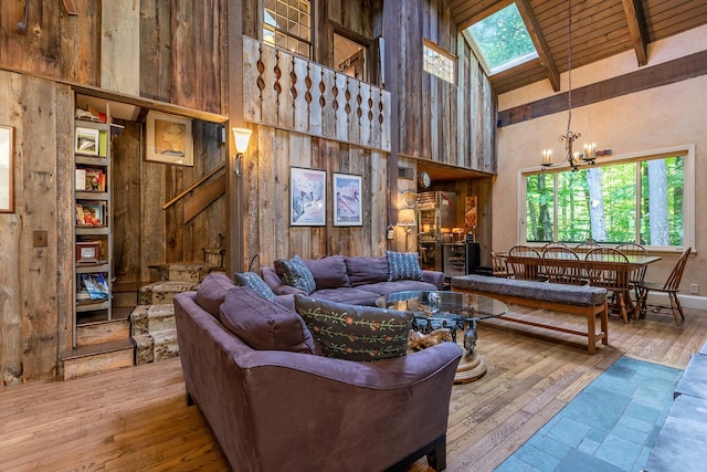 11 Founders Hill Rd, Winhall, VT 05340 - living room featuring hardwood / wood-style flooring, beam ceiling, high vaulted ceiling, an inviting chandelier, and a wealth of natural light