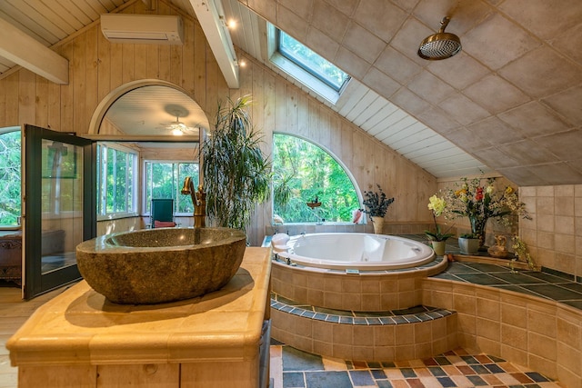 11 Founders Hill Rd, Winhall, VT 05340 - bathroom with a wall mounted air conditioner, lofted ceiling with skylight, a relaxing tiled tub, and wooden walls