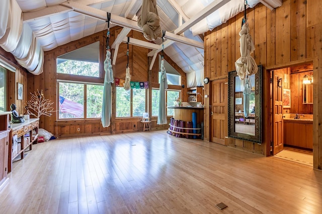 11 Founders Hill Rd, Winhall, VT 05340 - unfurnished living room featuring wooden walls, light wood-type flooring, and a sink