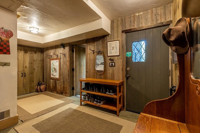 11 Founders Hill Rd, Winhall, VT 05340 - foyer with wood walls, visible vents, and carpet