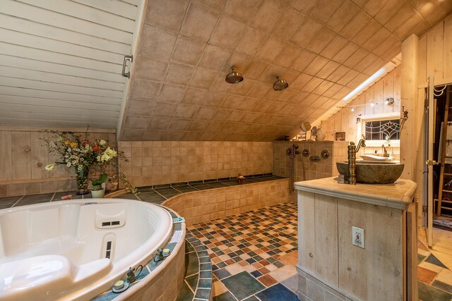 11 Founders Hill Rd, Winhall, VT 05340 - bathroom featuring lofted ceiling, a tub with jets, wood walls, and vanity