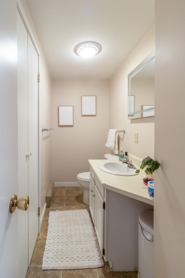 bathroom with toilet and vanity