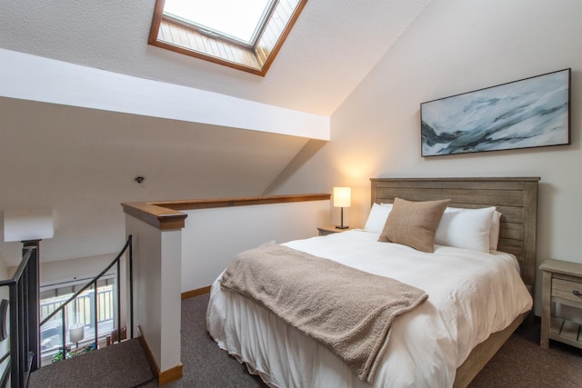 carpeted bedroom featuring vaulted ceiling with skylight