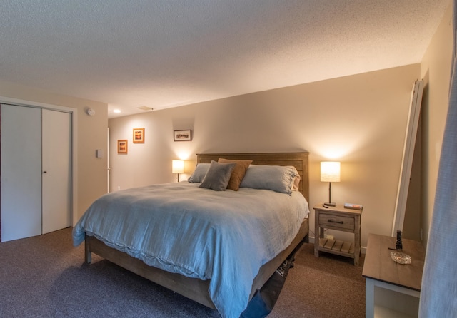 carpeted bedroom featuring a closet and a textured ceiling