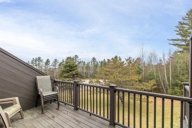 wooden terrace featuring a lawn