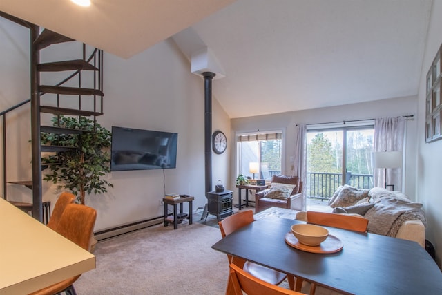 carpeted living room with a wood stove, lofted ceiling, and a baseboard radiator