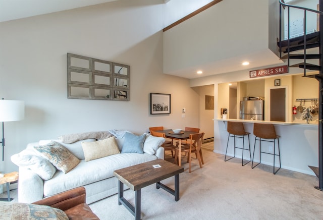 carpeted living room with a high ceiling