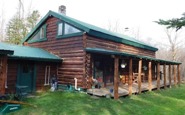 view of side of property featuring a lawn and a wooden deck