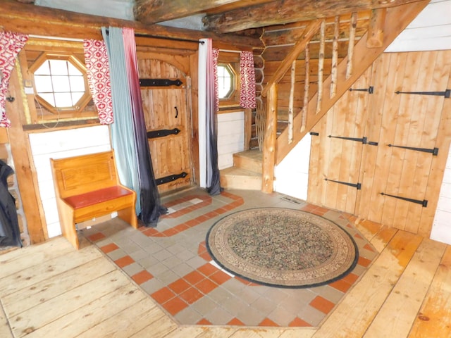 entrance foyer featuring wood walls and wood-type flooring