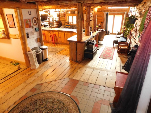 kitchen featuring kitchen peninsula, wooden walls, and light hardwood / wood-style floors