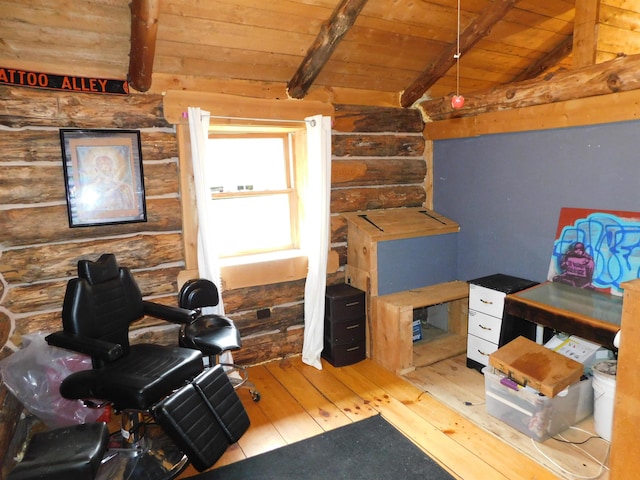 office space featuring hardwood / wood-style floors, vaulted ceiling with beams, log walls, and wooden ceiling