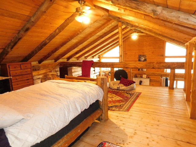 bedroom with multiple windows, hardwood / wood-style floors, and vaulted ceiling with beams