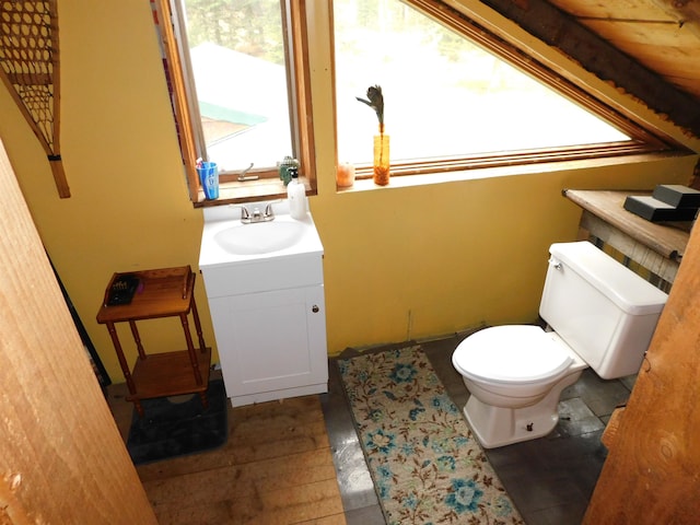 bathroom featuring toilet, vanity, and wood ceiling