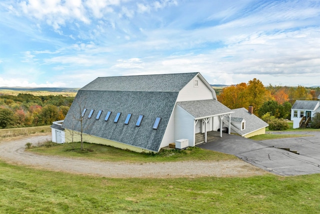 view of property exterior featuring a lawn and a carport