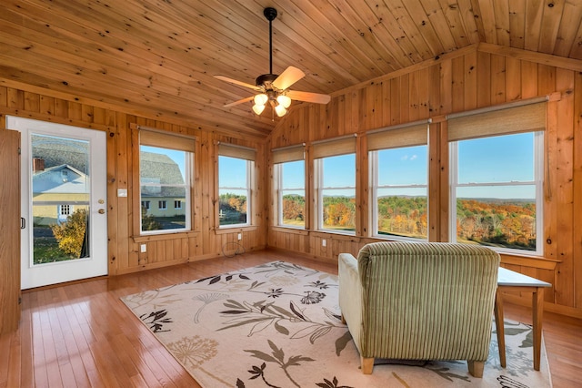 unfurnished sunroom featuring wood ceiling, ceiling fan, and vaulted ceiling