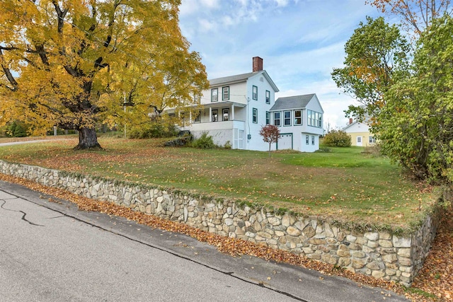 view of front of home with a front yard and covered porch