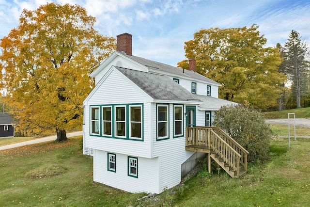 back of property featuring a yard