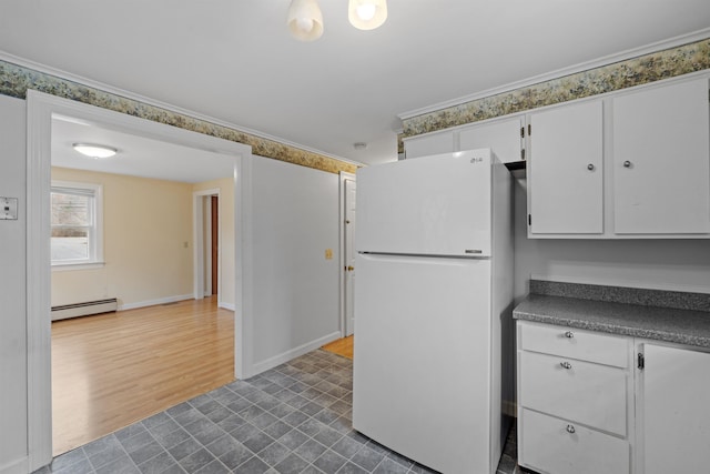 kitchen featuring white cabinets, dark hardwood / wood-style floors, a baseboard radiator, and white refrigerator