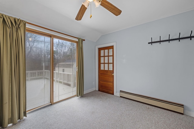 spare room with ceiling fan, baseboard heating, carpet flooring, and vaulted ceiling