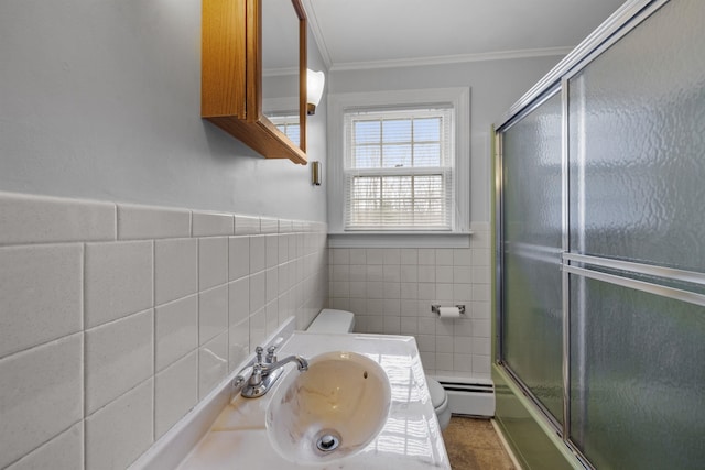 full bathroom featuring toilet, tile walls, sink, combined bath / shower with glass door, and crown molding