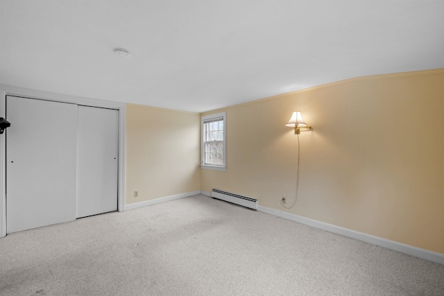 unfurnished bedroom featuring baseboard heating, light carpet, and a closet