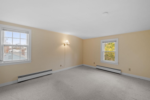 empty room with light carpet and a baseboard heating unit