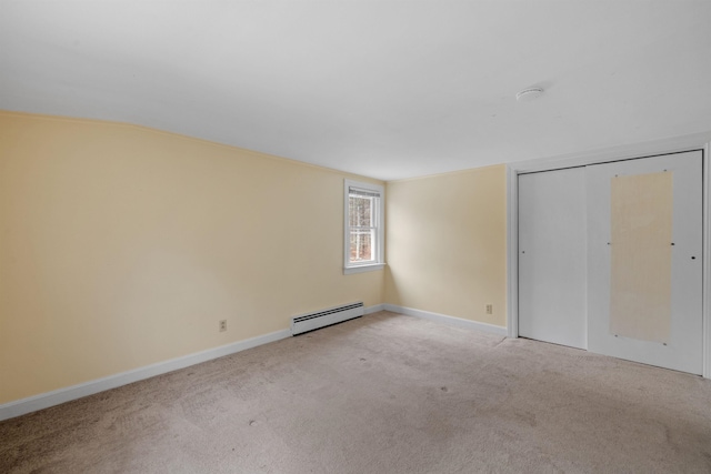 unfurnished bedroom with a baseboard radiator, light carpet, and a closet