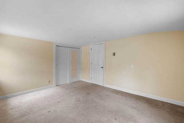 unfurnished room featuring light colored carpet